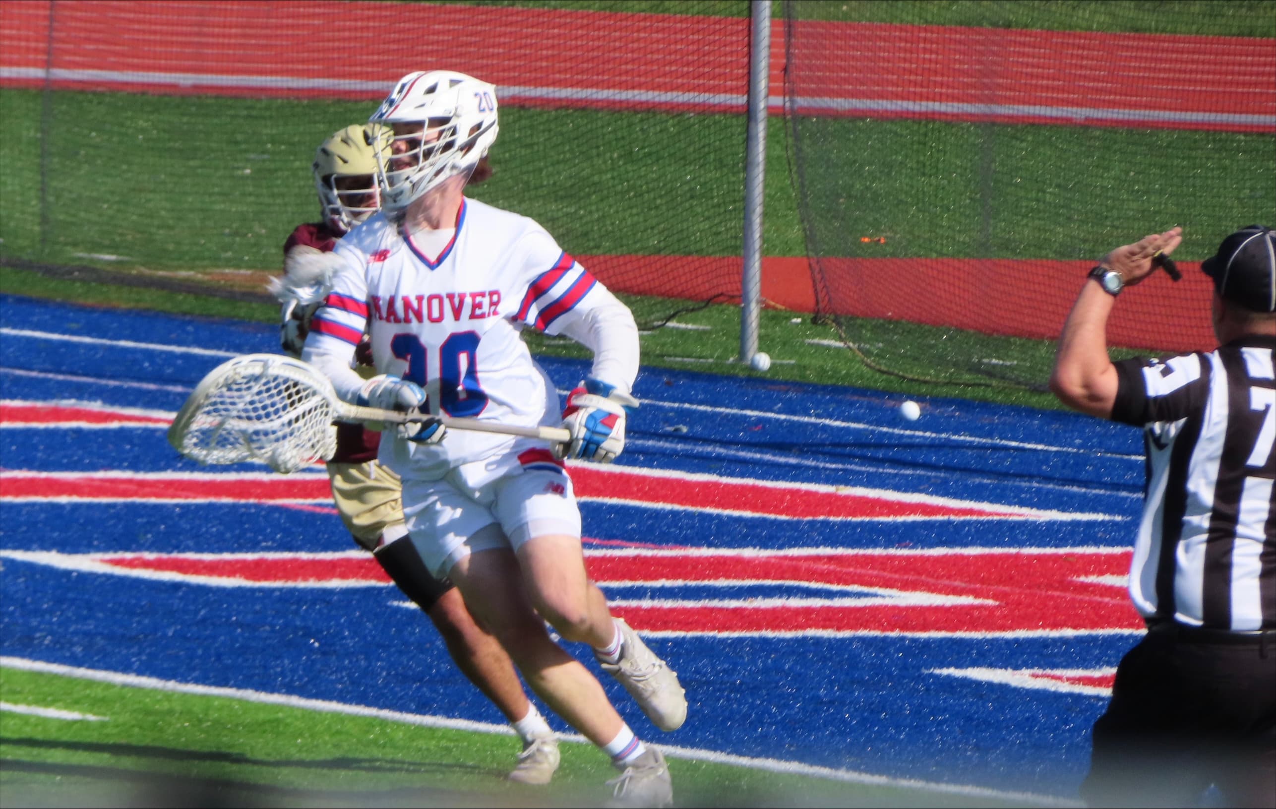 Collegiate lacrosse goalie making a save near the pipe